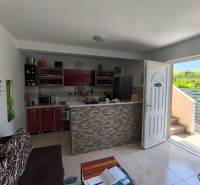 Living room and kitchen in a 2-room apartment with entrance and view into the courtyard.
