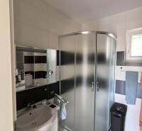 Bathroom with a shower and a sink in a 2-room apartment.