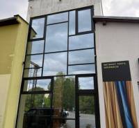 Glazed commercial spaces in Poprad with advertising for textile decorations.