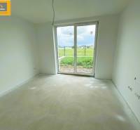 Spacious room with a large window and a view of the exterior, ideal for a 5 or more bedroom apartment.