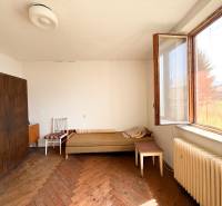 Room with furniture and a large window in a family house.