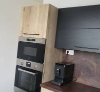 A kitchen unit with an oven and a coffee maker in a studio apartment.