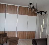 A wardrobe and an armchair in a studio apartment, a cozy space for relaxation.