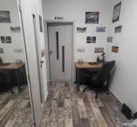 A small work corner in a studio apartment with decorations on the walls.