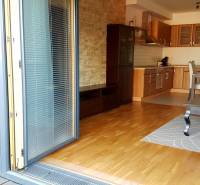 Living room with kitchen and dining table, 2-room apartment, wooden floor.