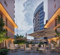 Construction of apartments on Panónska Road in Bratislava - Petržalka with a sunny terrace and garden furniture.