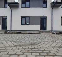 A family house on Zemianská Olča Street in the town of Zemianska Olča with a paved courtyard.