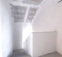 Interior of a family house with white walls and a staircase.