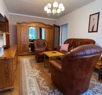 Leather armchairs and wooden furniture in the living room of a two-room apartment.
