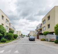 Agátová Street in Rovinka with apartment buildings and parked cars.