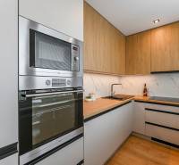 A kitchen in a 3-room apartment with a wooden cabinet and built-in appliances.