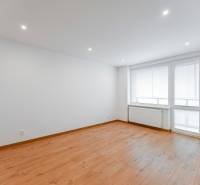 A bright room with blinds and wooden flooring in a 3-room apartment.