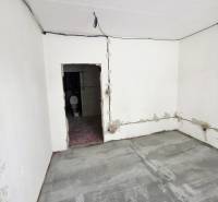 A room under renovation in a 2-room apartment with ceramic tiles and unfinished walls.