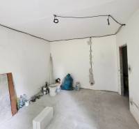 Under-construction interior of a 2-room apartment with visible electrical installations and building materials.