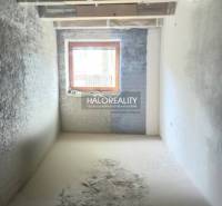 Renovation of a room in a family house with a wooden window and plastered walls.