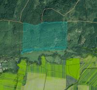 Aerial photograph of agricultural and forest land near Hranovnica, showing forests, fields, and buildings.