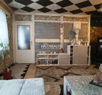 Bedroom in a family house with a bed, cabinet, and a plush teddy bear.