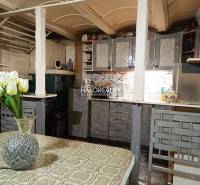 Dining room with wallpaper, dining table, and flowers in a family house.