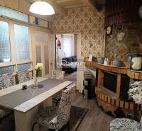 A comfortable living room in a family house with elegant wallpaper and stylish patterns.