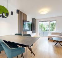 Dining table and living room in a 3-room apartment with a large window to the terrace.