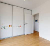 A room in a 3-room apartment with a large wardrobe on the wall with illustrations.
