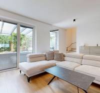A spacious living room with a comfortable sofa and glass doors in a 3-room apartment.