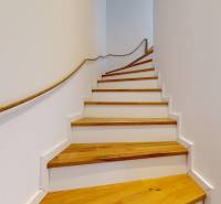 Wooden stairs in a 3-room apartment with a rope railing.