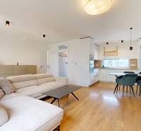 Living room with a comfortable sofa and dining table in a 3-room apartment.