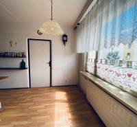 A room with curtains, a view, wooden floor, and a shelf in a 4-room apartment.