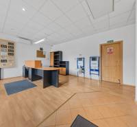 Office space in a family house with wooden flooring, a desk, and shelves.