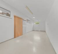 A bright room with white walls and wooden sliding doors in a family house.