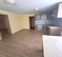 A kitchen in a 4-room apartment with a light floor and wooden furniture.