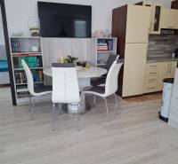 Dining room with a library and kitchen in a 4-room apartment.