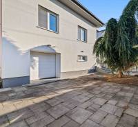 Two-story family house on Pluhová Street with a garage and a driveway.