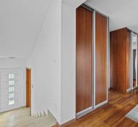 Interior of a family house with wooden floors and cabinets on Pluhová Street.