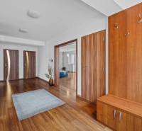 A spacious hall with wooden furniture on Pluhová Street, entrance to a family house.