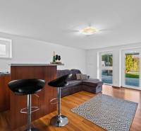 Living room on Pluhová street, family house, bright with a bar counter and a sofa bed.