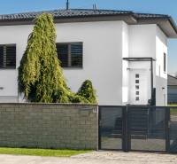 A family house on Pluhova Street in Ivanka pri Dunaji with a modern fence and greenery.