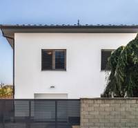 A family house on Pluhova Street in Ivanka pri Dunaji with a garden and a gate.