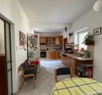 Kitchen with dining area, tiled floor, wooden furniture, 5 or more room apartment.