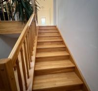 A staircase with a wooden decor leads to the upper floor in a 5 or more room apartment.