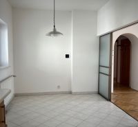 See a dining area in a 5 or more room apartment with tiles and a lamp.