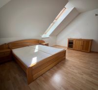 A bedroom with a wood-decor floor in a 5 or more room apartment, attic room.