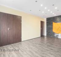 Interior of a 3-room apartment with wooden floors, dark doors, and a black wall.