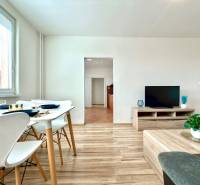Living room in a 3-room apartment with a dining area and a television.