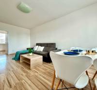 Living room in a 3-room apartment with a sofa, table, and set dining area.