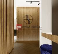 Interior of a 4-room apartment with a wooden wall and modern elements, includes a wall clock.