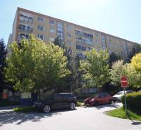Apartment building on Karpatská Street in Prešov, surrounded by trees and parked cars.