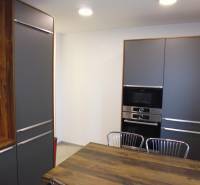 A kitchen in a 3-room apartment with wooden and metal elements.