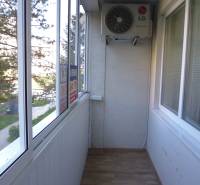Glazed balcony with air conditioning and a view within a 3-room apartment.